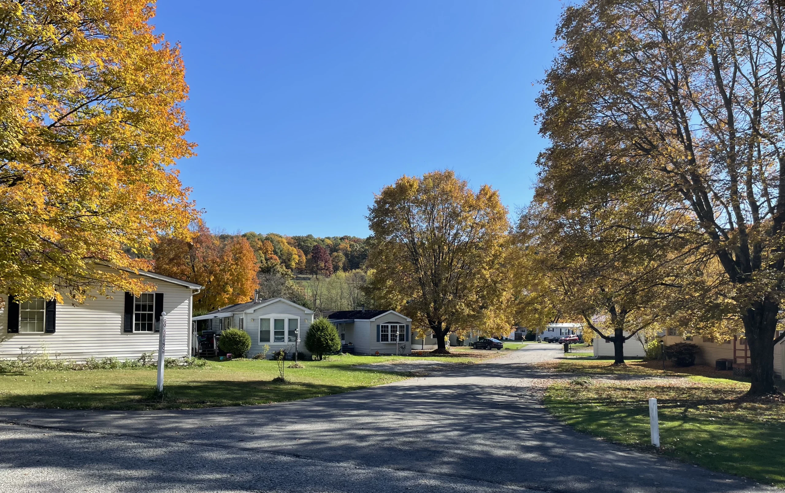 View of a mobile home community from the street in the fall.